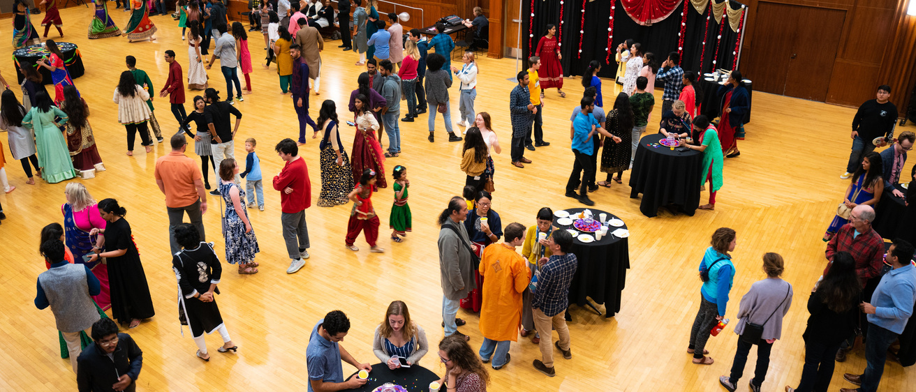 Aerial view of the IMU second floor ballroom, with people talking and eating