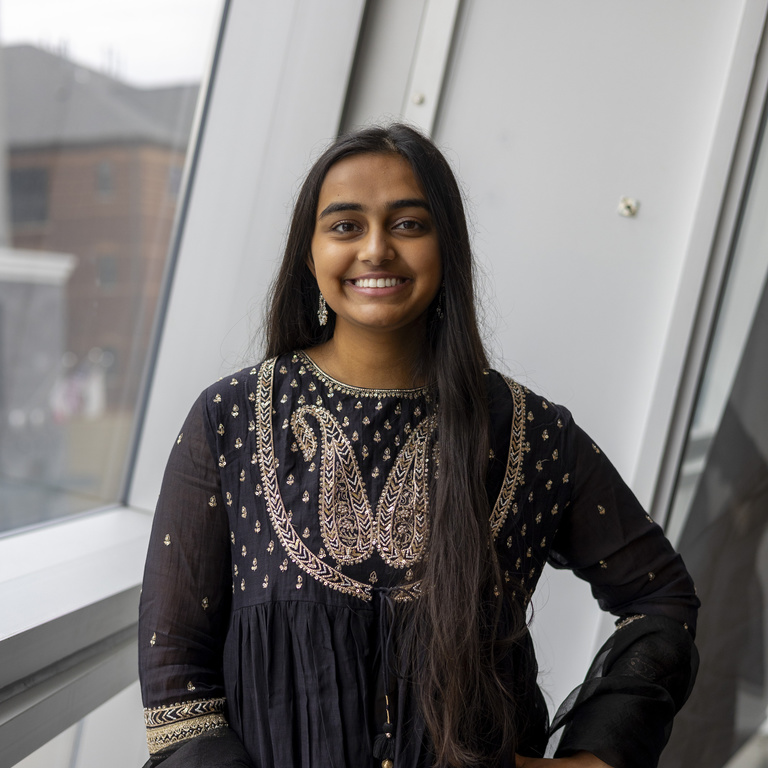 Sanjna smiling at camera